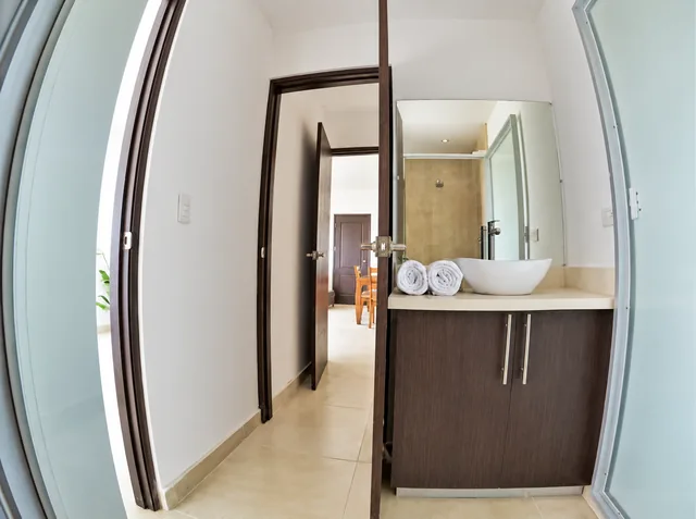 Private bathroom with vanity and glass-enclosed shower