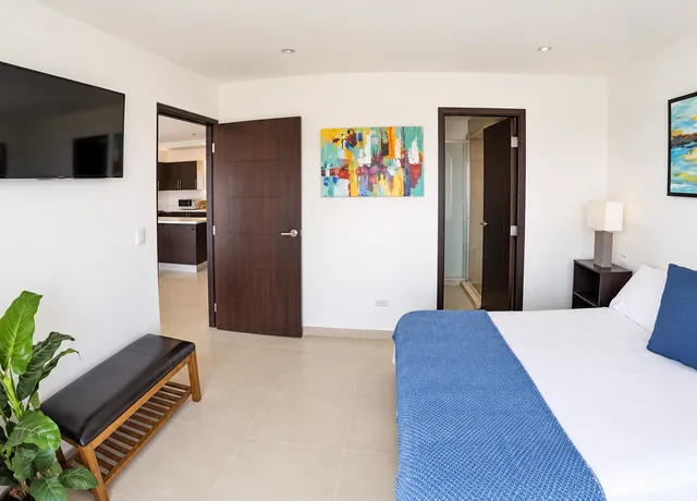 Main bedroom with television and comfortable seating