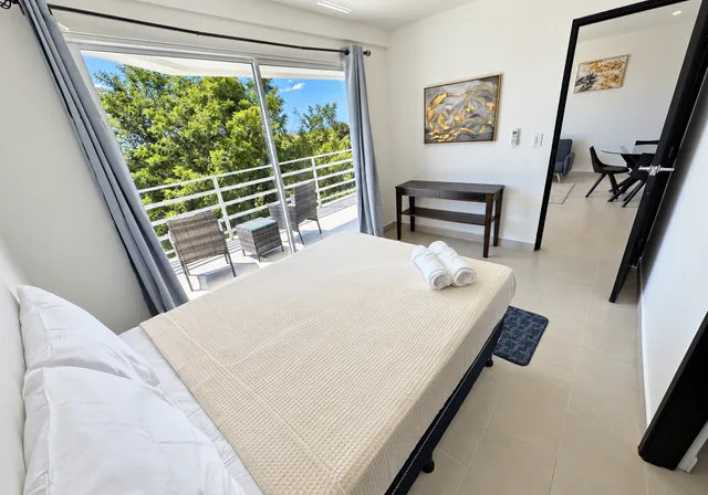Bright bedroom overlooking the furnished balcony