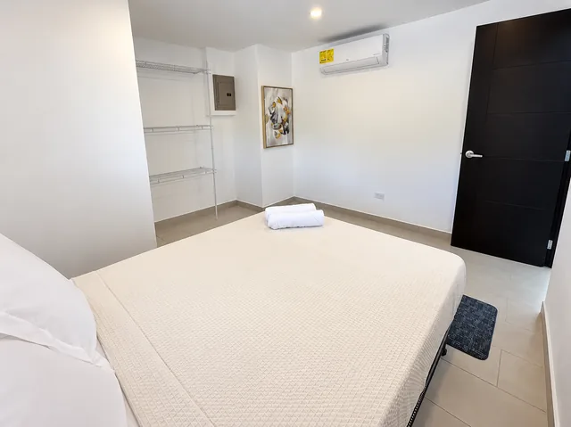 Air-conditioned guest bedroom with fresh linens
