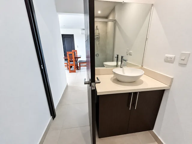 Bathroom vanity and mirror beside the living area