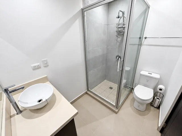 Private bathroom with a glass-enclosed shower