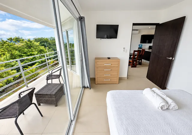Bedroom opening onto the furnished balcony