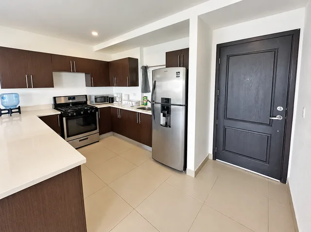 Kitchen with stove, refrigerator and ample counter space