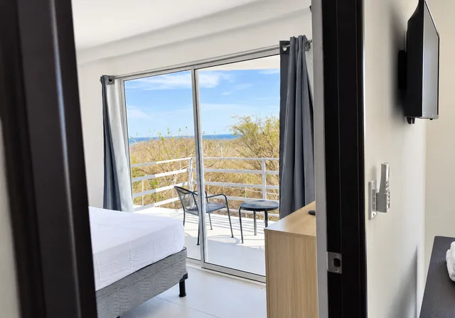 Bedroom opening onto the ocean-view balcony