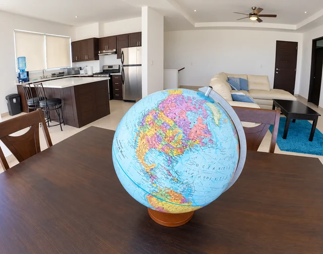 Dining area with a globe, open kitchen and lounge