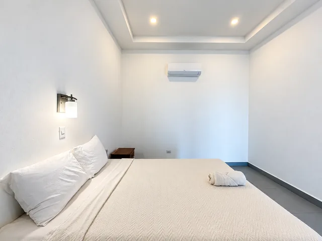 Guest bedroom with a double bed and bedside lighting