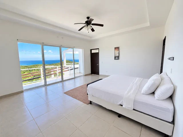 Bedroom with a terrace and views of the ocean