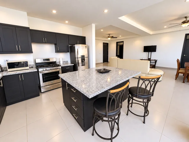 Open kitchen with breakfast island and dining area