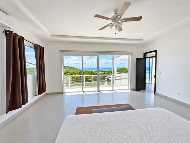 Spacious bedroom opening onto an ocean-view terrace