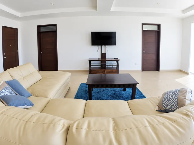 Spacious lounge with a sectional sofa and television
