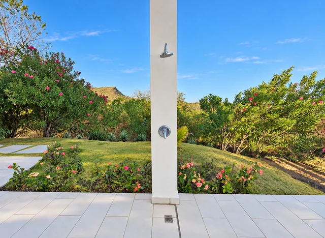 Outdoor shower beside tropical gardens