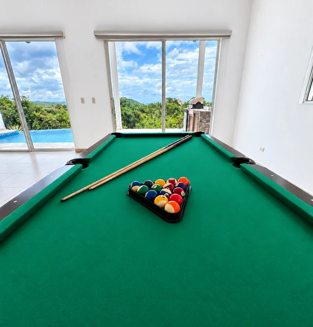 Green pool table with ocean views