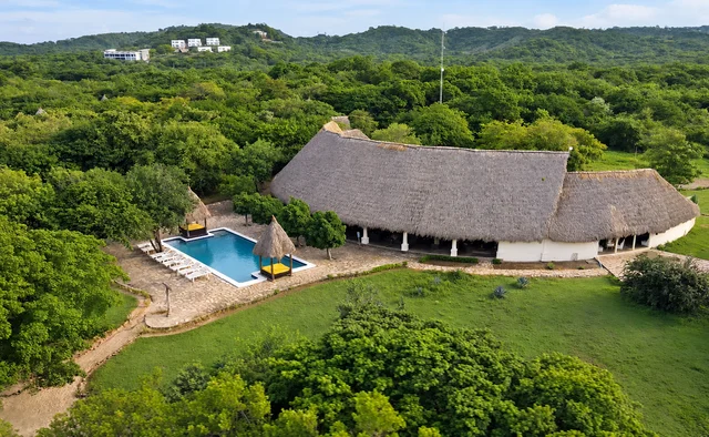 Nearby beachfront pool and thatched-roof building