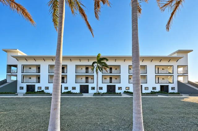 Condominium building framed by palm trees